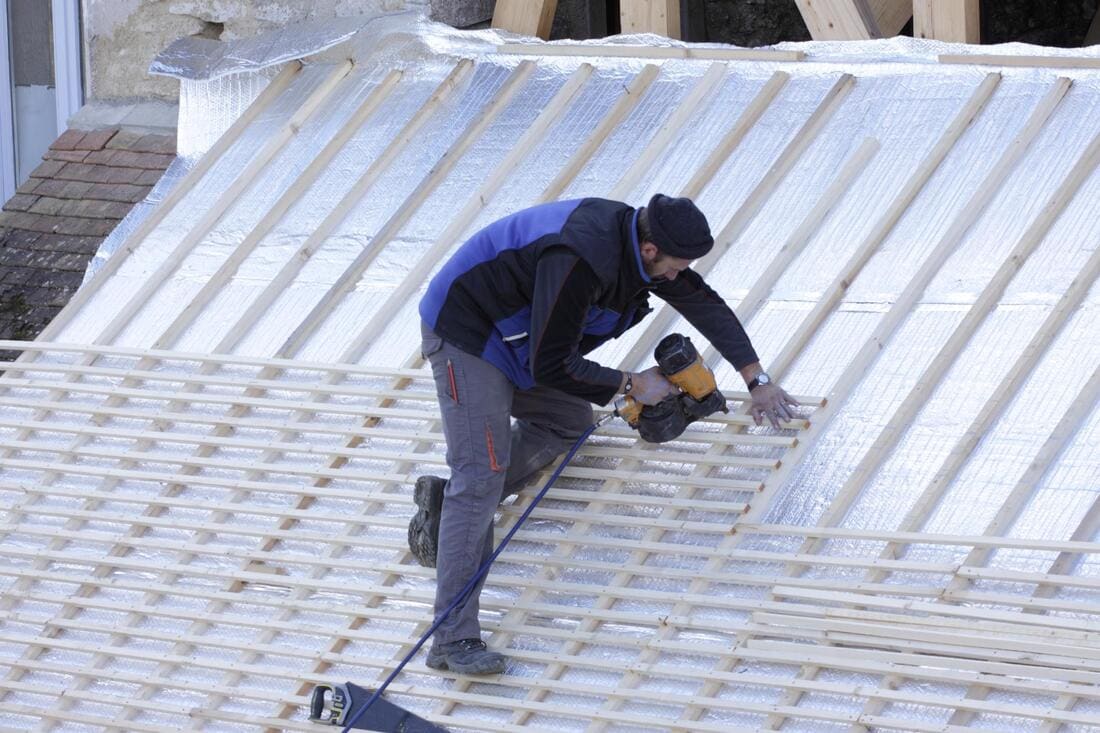Roof crew working on a low-slope roof section